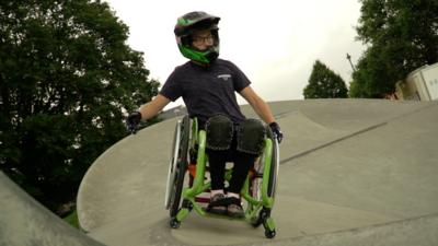 Lily Rice riding her wheelchair on a skatepark