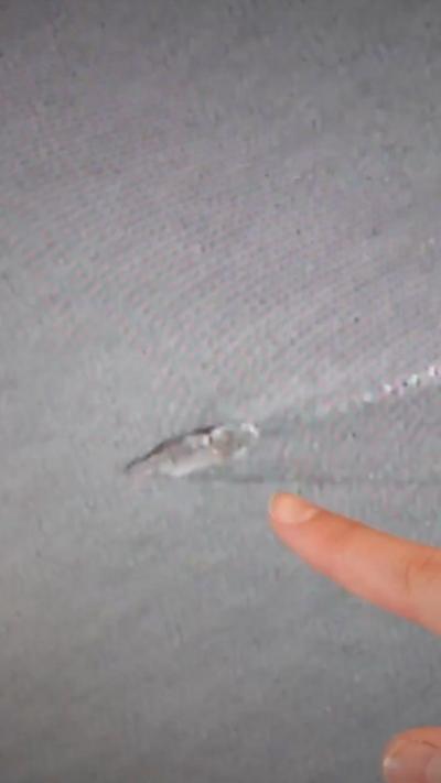 Finger pointing at image of carrier
