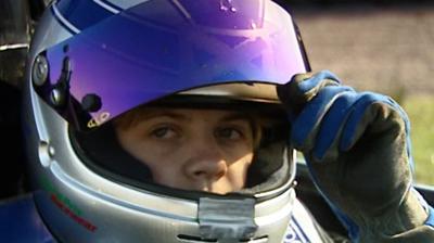 Close up of racing driver Susie Stoddart wearing a crash helmet in her F4 car.