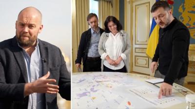 (L) James Waterhouse, (R) President Zelensky looking at a map