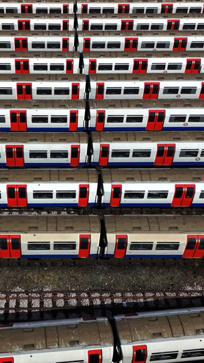 Line of Tube trains parked at depot.