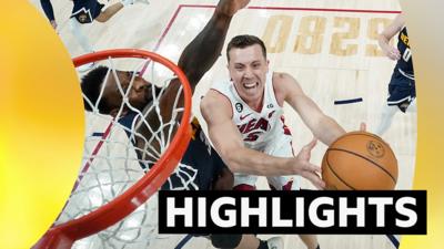 Miami Heat's Duncan Robinson scores against the Denver Nuggets