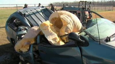 A big pumpkin is dropped on a car