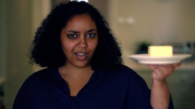 Fatma Wardy holds up block of butter