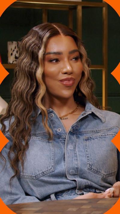 Munroe Bergdorf sits in a podcast studio wearing a denim shirt, with long wavy hair.