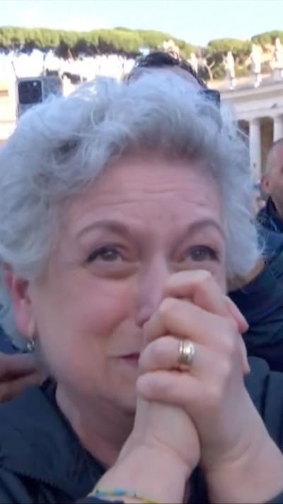 Woman holds hands in prayer in front of her face