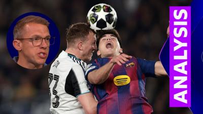 Dan Burn challenges a Barcelona player