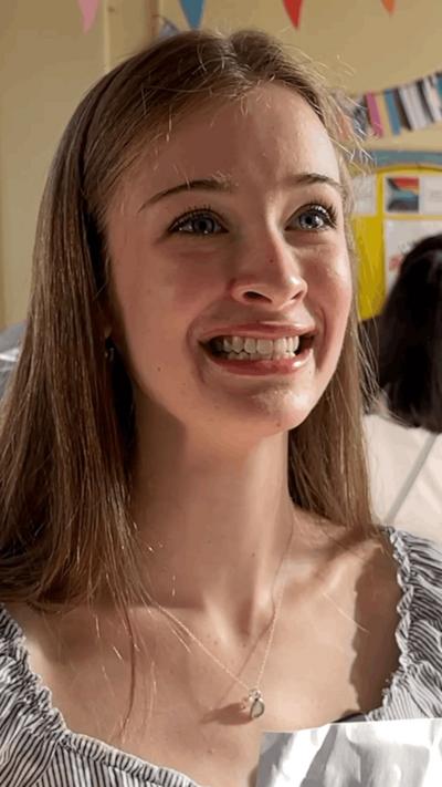 Close-up girl with brown hair looking emotional 