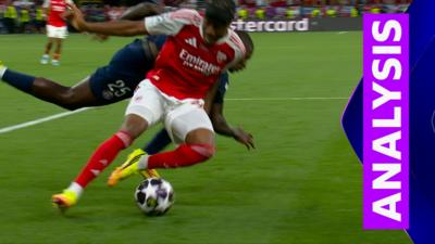 Arsenal's Noni Madueke and PSG's Nuno Mendes tussle for the ball