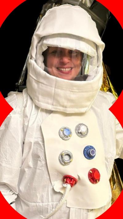 Woman in a white spacesuit and helmet. 