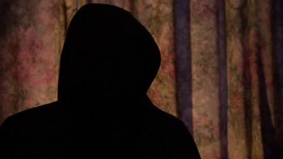 Silhouette of man in hooded top