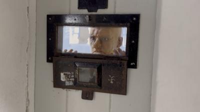 Visitors are confronted with scenes such as models of prisoners staring out of cells