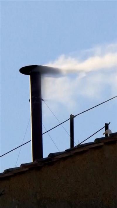 White smoke billows from chimney