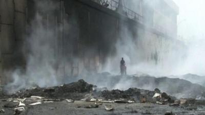 View of smoke rising from the warehouse