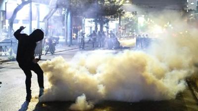 Protesters clash with riot police outside of the offices of the Hellenic Train company