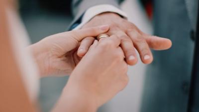 Bride place ring on husbands hand