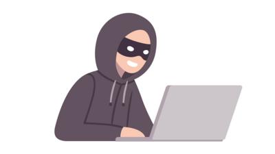 A masked person using a laptop