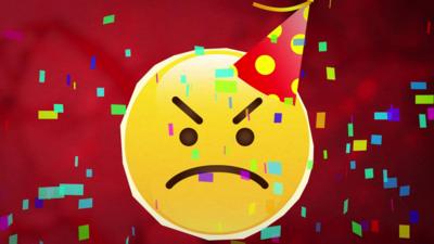 An angry face emoji wearing a party hat