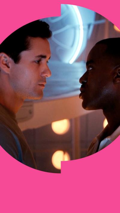 The Doctor and Conrad stand face-to-face, looking at each other intensely, inside the Tardis