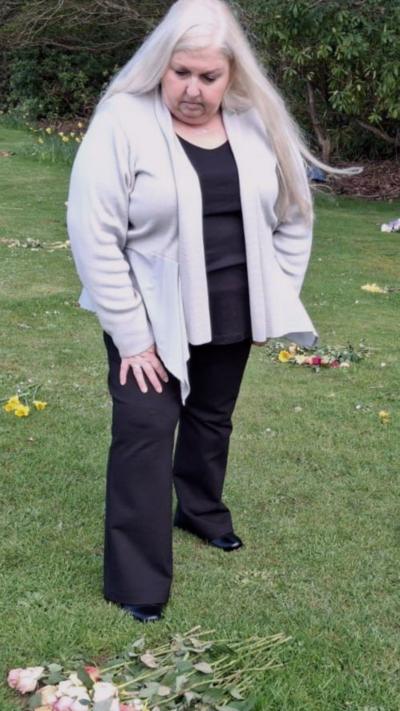 A woman in a grey top with blonde hair