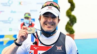 British para-rower Benjamin Pritchard celebrates his silver medal at the European Championships in Italy.