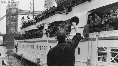 A person waves a hat towards the pleasure steamer 'Royal Daffodil' on the River Thames, near Tower Bridge.