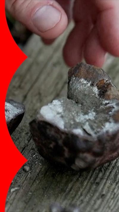 A hand next to a rock