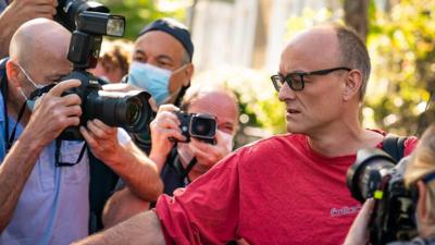 Dominic Cummings surrounded by photographers