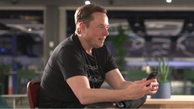 Elon Musk on his phone