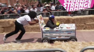 A man pushing a soapbox