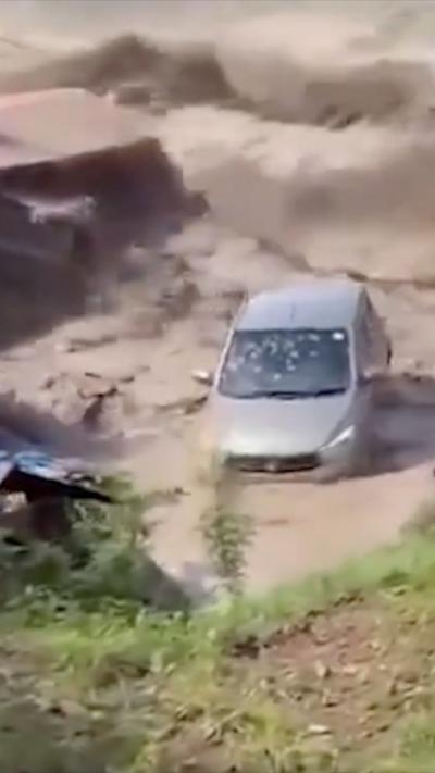 Silver car in brown water 