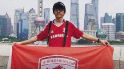 Aki holding a Middlesbrough FC flag