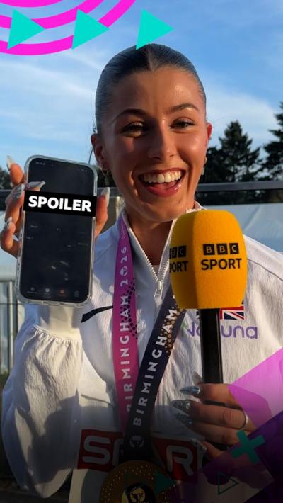 Amy Hunt smiling and holding phone