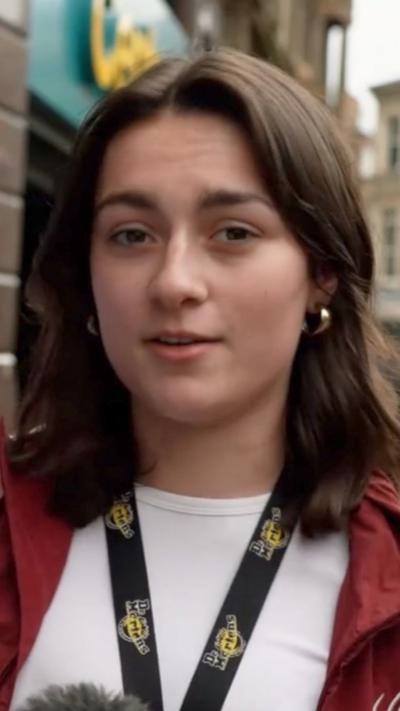 Woman stares at camera as she speaks