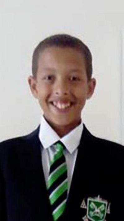 Noah Donohoe is a white shirt, green black and white tie and a black school blazer. 