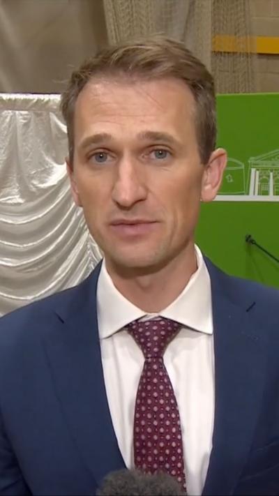 Man in blue blazer, white shirt and burgundy tie