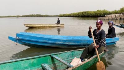 Oyster farmers in boats