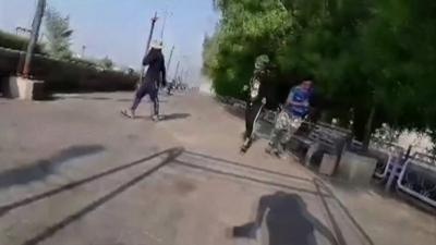 Protesters flee from the sound of gunfire in Iraq’s southern city of Nasiriya