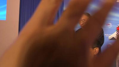 A BBC cameraman finds their vision blocked as they try to film a Chinese communist party meeting