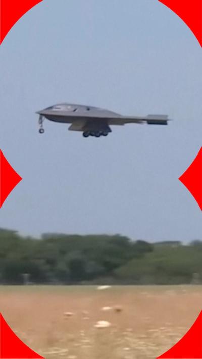 B-2 bomber with landing gear out descending onto airfield