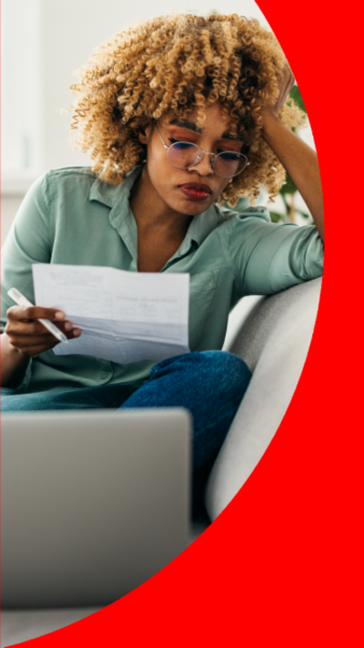 A woman looking at an energy bill