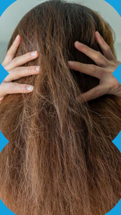 Hands attempt to smooth down frizzy hair