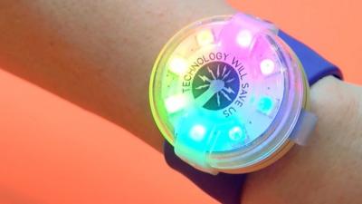 A light-up gadget strapped to a wrist