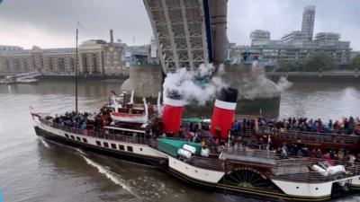 A sea-going paddle steamer passes under London's Tower Bridge