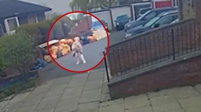 Doorbell camera captures moment buzzard flies over a woman in her dressing gown.