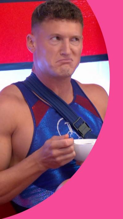 Legend sits eating a bowl of cereal, he has a bemused expression on his face