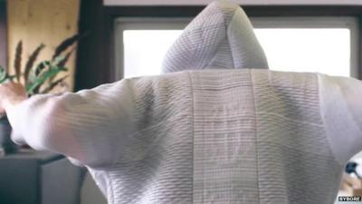 A man wearing a 'smart' suit that can clean the air