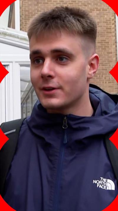 A young man with shor hair wearing a blue jacket