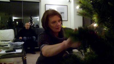 Chris Roberts watching his wife Jayne decorate the Christmas tree