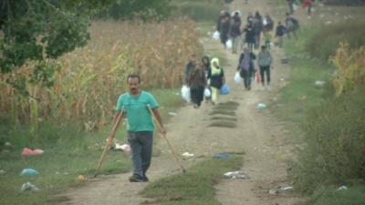 People trek through Croatian fields